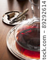 Corkscrew and red wine in decanter 89292614