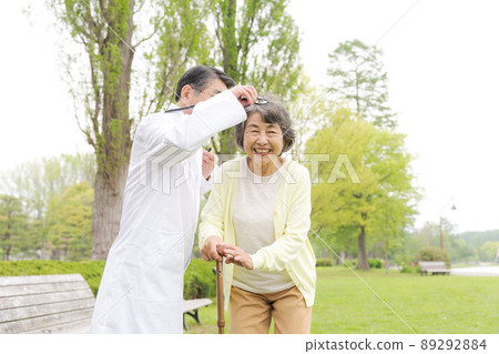 Doctor and senior woman outdoors Doctor and senior woman outdoors 89292884