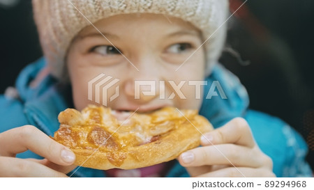 Child eat pizza cheese four. Close up of young girl woman eating pizza and chewing in outdoor restaurant. Kid children hands taking piece pizza. Child eat pizza cheese four. Close up of young girl woman eating pizza and chewing in outdoor restaurant. Kid children hands taking piece pizza. 89294968