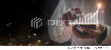 Businessman hand holds mobilephone with stock market chart. Business man analysis screen chart with mobile phone. business stock market concept Businessman hand holds mobilephone with stock market chart. Business man analysis screen chart with mobile phone. business stock market concept 89295354