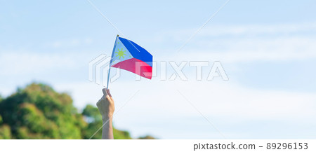 hand holding Philippines flag on nature background. 12th June of Independence day and happy celebration concepts hand holding Philippines flag on nature background. 12th June of Independence day and happy celebration concepts 89296153