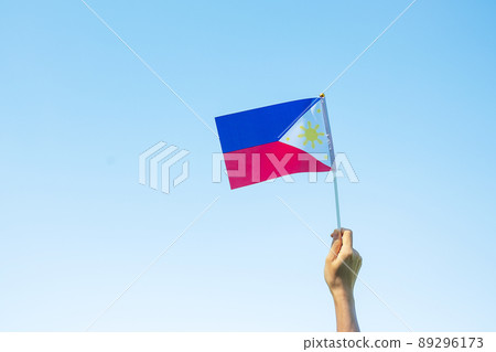 hand holding Philippines flag on nature background. 12th June of Independence day and happy celebration concepts hand holding Philippines flag on nature background. 12th June of Independence day and happy celebration concepts 89296173