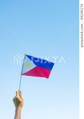 hand holding Philippines flag on nature background. 12th June of Independence day and happy celebration concepts hand holding Philippines flag on nature background. 12th June of Independence day and happy celebration concepts 89296174