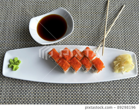 Rolls with salmon and cheese in a plate and soy sauce  89298196