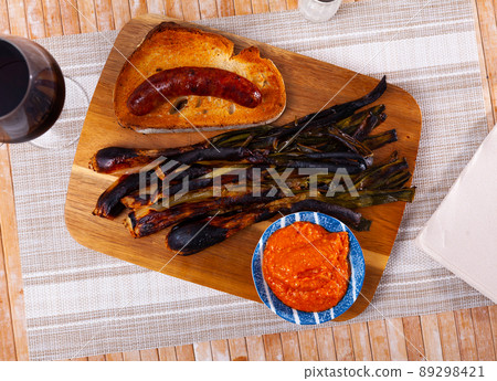 Traditional spanish foods - calsot, romesco, butifarra closeup Traditional spanish foods - calsot, romesco, butifarra closeup 89298421