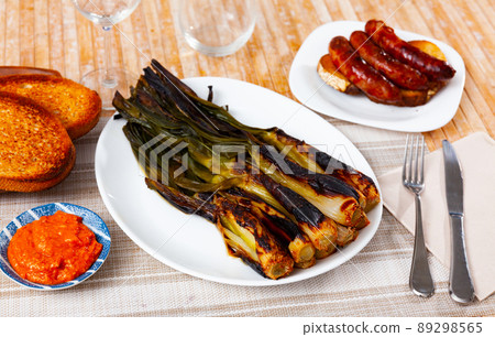 Traditional spanish foods - calsot, romesco, butifarra closeup Traditional spanish foods - calsot, romesco, butifarra closeup 89298565