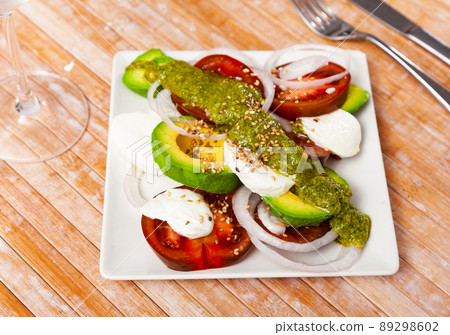 Caprese salad with avocado served on plate Caprese salad with avocado served on plate 89298602