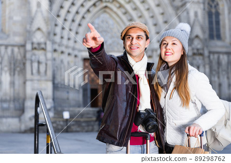 Male and female in the historic center pointing finger Male and female in the historic center pointing finger 89298762