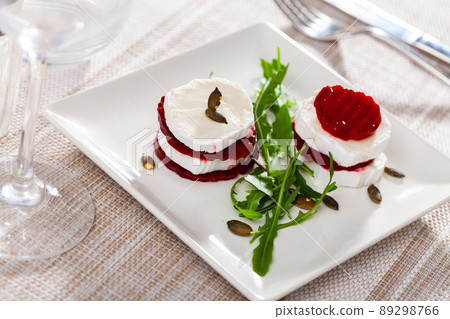 Fresh beetroot and goat cheese salad served on plate Fresh beetroot and goat cheese salad served on plate 89298766