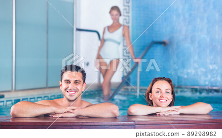 Portrait of couple who is resting in pool in spa salon. Portrait of couple who is resting in pool in spa salon. 89298982
