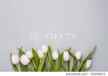 Spring background with white tulips. Mockup for spring greeting card. 89299011