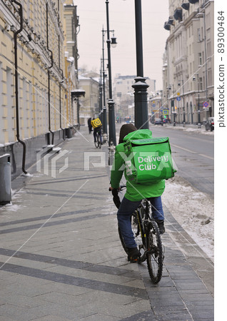 food delivery man on a bicycle in moscow 89300484