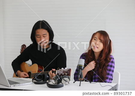 Portrait of men musician playing guitar in studio. 89301737