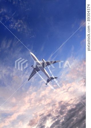 Vertical nature background with aircraft and Jet trailing smoke in sunset sky. Airplane and condensation trail 89304374