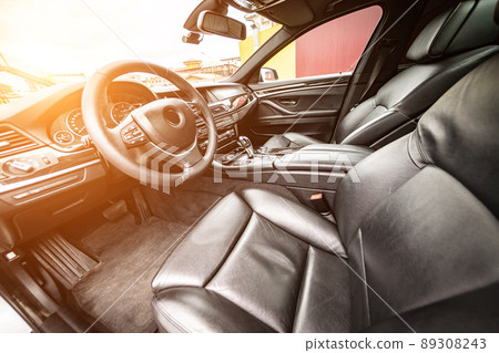 Car inside. Interior of prestige modern car. Comfortable leather seats. Black cockpit with on isolated white background. Car inside. Interior of prestige modern car. Comfortable leather seats. Black cockpit with on isolated white background. 89308243
