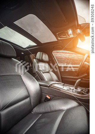 Car inside. Interior of prestige modern car. Comfortable leather seats. Black cockpit with on isolated white background. 89308248
