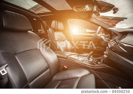 Car inside. Interior of prestige modern car. Comfortable leather seats. Black cockpit with on isolated white background. Car inside. Interior of prestige modern car. Comfortable leather seats. Black cockpit with on isolated white background. 89308250
