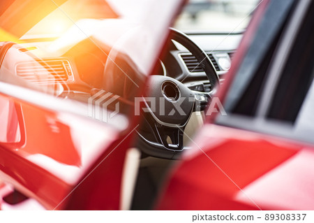 Modern luxury prestige car interior, dashboard, steering wheel. Orange red car interior. 89308337