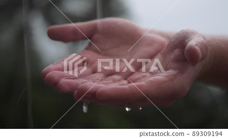 Rain water drop to the hands man with green nature on background, environment recovery 89309194