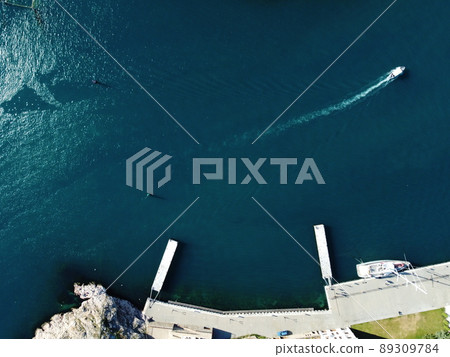 Aerial panoramic view of Balaklava landscape with boats and sea in marina bay on sunny day. Crimea Sevastopol tourist attraction. Drone top view shot of port for luxury yachts, boats and sailboats Aerial panoramic view of Balaklava landscape with boats and sea in marina bay on sunny day. Crimea Sevastopol tourist attraction. Drone top view shot of port for luxury yachts, boats and sailboats 89309784