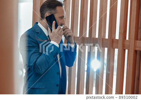 Adult man having an important conversation on the phone 89310002