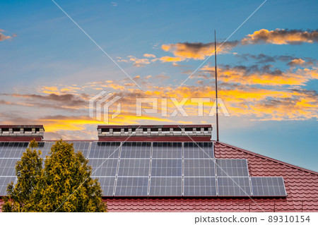 Photovoltaic or solar panels on roof at sunset 89310154