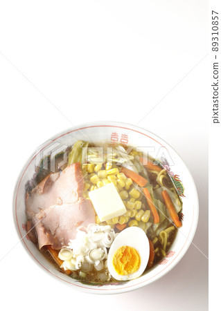 A bird's-eye view of the hot, rich miso butter corn ramen with stir-fried vegetables, char siu, and boiled eggs on a white background. A bird's-eye view of the hot, rich miso butter corn ramen with stir-fried vegetables, char siu, and boiled eggs on a white background. 89310857