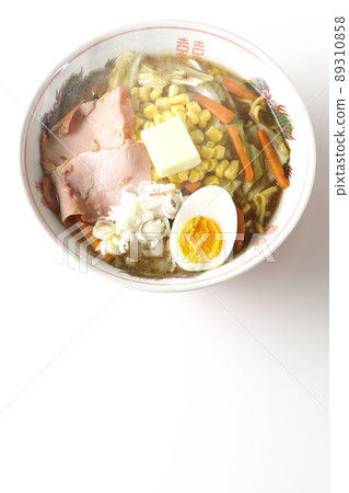 A bird's-eye view of the hot, rich miso butter corn ramen with stir-fried vegetables, char siu, and boiled eggs on a white background. A bird's-eye view of the hot, rich miso butter corn ramen with stir-fried vegetables, char siu, and boiled eggs on a white background. 89310858