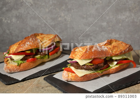 Burger with Baguette Bread on the wooden table Burger with Baguette Bread on the wooden table 89311003