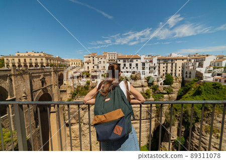 Girl tourist exploring the city on the rocks of Ronda, Spain Girl tourist exploring the city on the rocks of Ronda, Spain 89311078