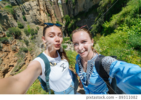 Tourist girl on the background of the famous bridge in Ronda, Spain 89311082