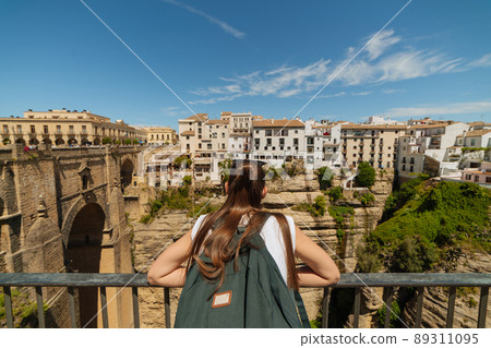 Girl tourist exploring the city on the rocks of Ronda, Spain 89311095