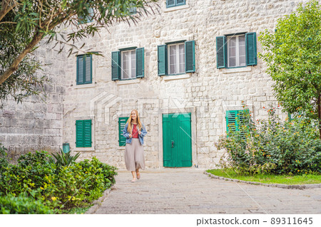 Woman tourist enjoying Colorful street in Old town of Kotor on a sunny day, Montenegro. Travel to Montenegro concept Woman tourist enjoying Colorful street in Old town of Kotor on a sunny day, Montenegro. Travel to Montenegro concept 89311645