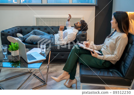 Professional psychotherapist conducting a therapy session for her patient Professional psychotherapist conducting a therapy session for her patient 89312230