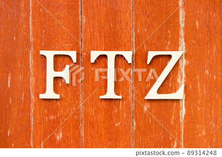 Alphabet letter in word FTZ (Abbreviation of Free trade zone) on old red color wood plate background Alphabet letter in word FTZ (Abbreviation of Free trade zone) on old red color wood plate background 89314248