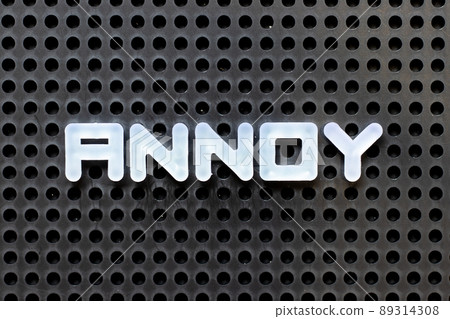 White color alphabet with word annoy on black pegboard background White color alphabet with word annoy on black pegboard background 89314308