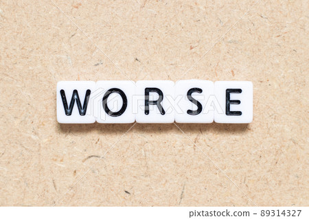 White tile alphabet letter with word worse on wood background White tile alphabet letter with word worse on wood background 89314327