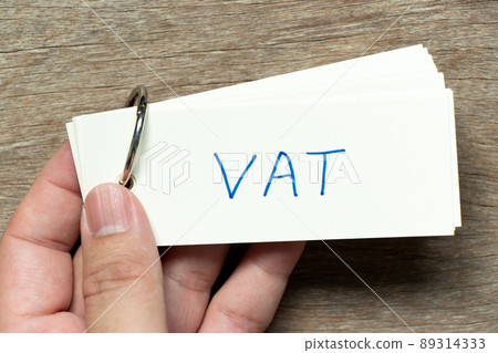 Man hold the flash card with handwriting word VAT (abbreviation of value added tax) on wood background 89314333