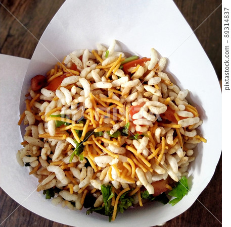 Bhel poori, an Indian road side snack in a conical shape paper container 89314837