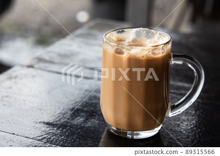 Teh Tarik, is infused black tea with milk served in thick froth. Popular drinks in Malaysia 89315566