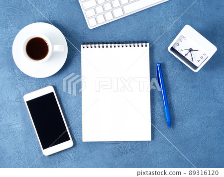 The open notepad with clean white page, pen and coffee cup on aged dark blue stone table, top view The open notepad with clean white page, pen and coffee cup on aged dark blue stone table, top view 89316120
