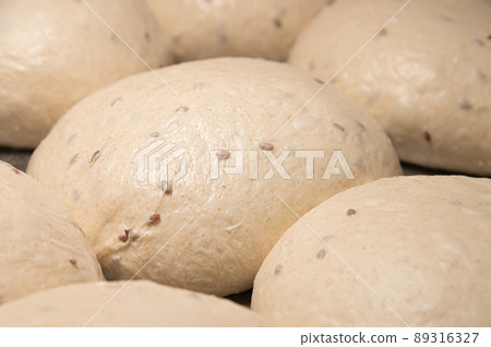 Raw burger buns dough on a metal baking sheet. Preparing ingredients for burgers 89316327