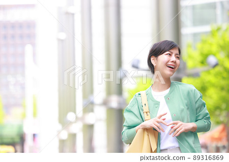 Woman walking in the fresh green city 3 89316869
