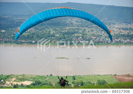 Paragliding sport at Mekong river Nong Khai, Thailand. Paragliding sport at Mekong river Nong Khai, Thailand. 89317306