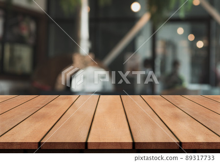 Empty wooden table top with lights bokeh on blur restaurant background. Empty wooden table top with lights bokeh on blur restaurant background. 89317733