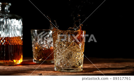 Detail of splashing whisky from glass. 89317761
