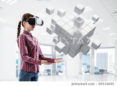 Girl in virtual reality mask experiencing virtual technology world. Mixed media 89318695