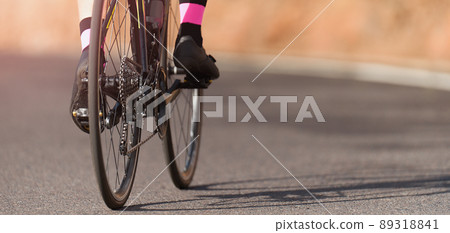 Racing bike detail on gear wheels and feet Racing bike detail on gear wheels and feet 89318841