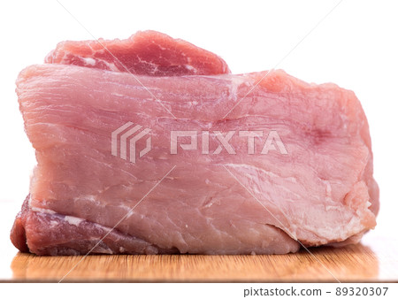 Close-up slice of fresh pork meat on a cutting board. Close-up slice of fresh pork meat on a cutting board. 89320307