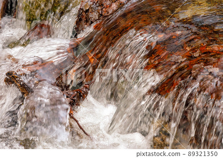 Waterfall on a stream with colorful autumn leaves. 89321350
